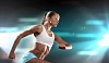 Fitness woman standing against color lights background