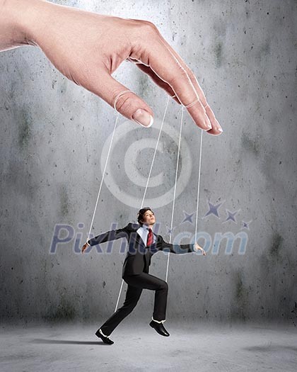 Businessman marionette on ropes controlled by puppeteer Businessman marionette on ropes controlled by puppeteer