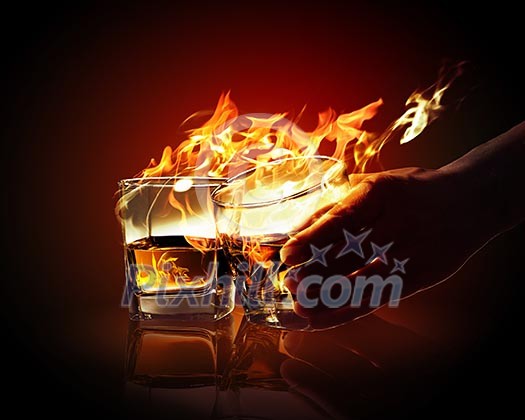 Image of two glasses of burning yellow absinthe