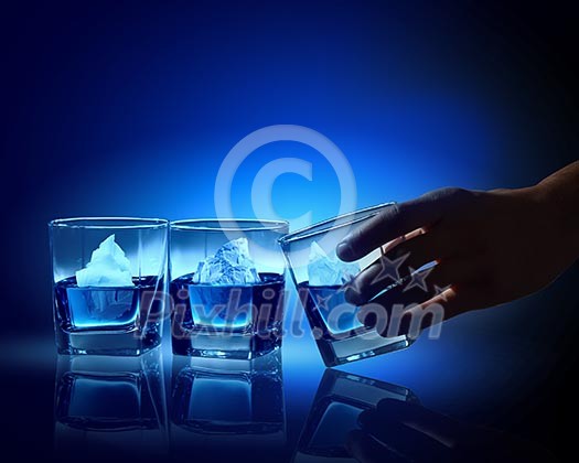 Three glasses of blue liquid with icebergs in Three glasses of blue liquid with icebergs in