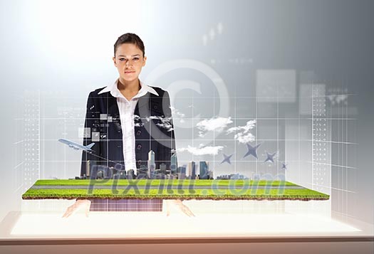 Image of young businesswoman holding cup standing against high-tech picture