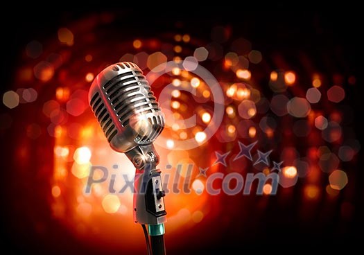 Single retro microphone against colourful background with lights