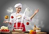 Asian female cooking with magic against color background