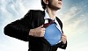 Image of young businessman showing superhero suit underneath his shirt