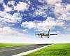 Image of a white passenger plane and blue sky with clouds