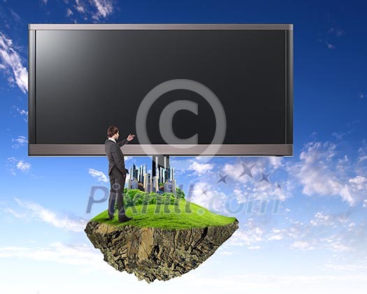 Business person standing near a blank billboard Business person standing near a blank billboard