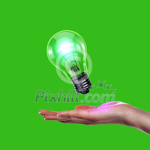 Human hand holding a shining electric bulb