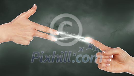Two human hands in contact with bright flash Two human hands in contact with bright flash
