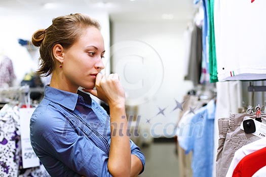 Young girl in a shop buying clothes Young girl in a shop buying clothes