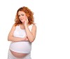 Charming red-haired young woman awaiting the birth of the baby.