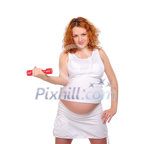 Young red-haired pregnant girl is engaged in sports.