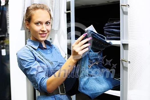 Young girl in a shop buying clothes Young girl in a shop buying clothes
