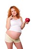 Young redhead pregnant mom thinks about healthy food