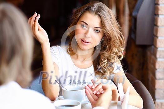 Portrait of young pretty woman sitting in restaurant Portrait of young pretty woman sitting in restaurant