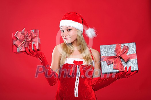 Portrait of a young charming girl dressed as Santa with a gift in their hands. Happy New Year!