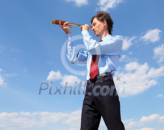 young business man in a blue shirt and red tie against the blue sky looks through a telescope. a symbol of leadership, success and freedom.