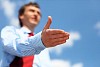 young businessman in a blue shirt and red tie giving a hand for a handshake