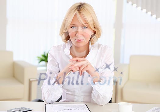 portrait of young business woman with blond hair in the office