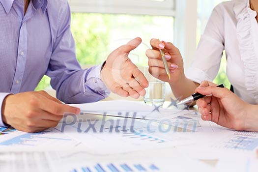 financial and business documents on the table and human hands