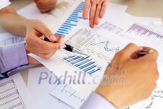 financial and business documents on the table and human hands