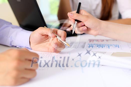 financial and business documents on the table and human hands