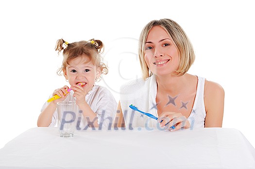 young mother and her young daughter brush their teeth on a white background
