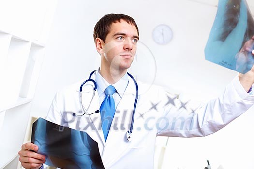 Young confident and friendly doctor in medical office