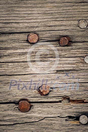 Old rusty nails on wooden background