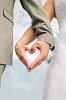 Hands of a bride and groom shaped as a heart