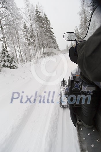 Snowmobile on the snowy road Snowmobile on the snowy road