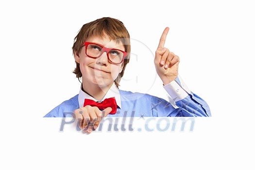 Image of young boy smiling thoughtfully holding white square. Place for advertisement