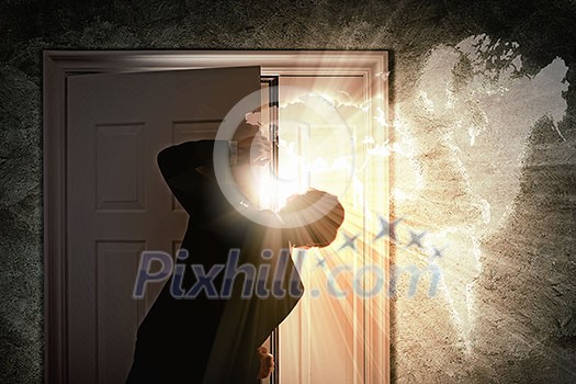 Image of young businessman opening the door