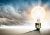 Image of light bulb against nature background. Ecological concept