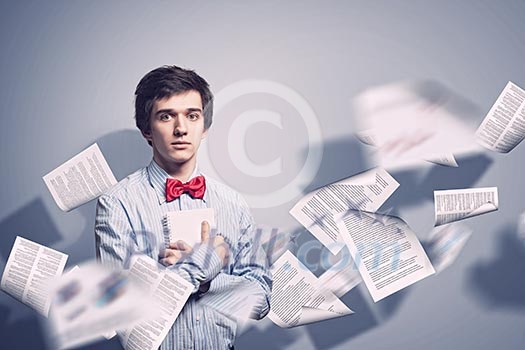 Image of young tired man holding folder with documents