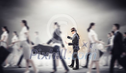 Image of businessman in blindfold walking among group of people Image of businessman in blindfold walking among group of people