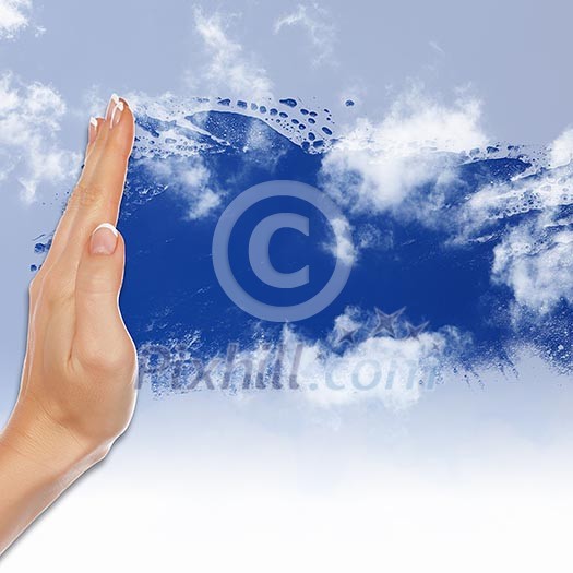 Hand cleaning window with blue sky and white clouds