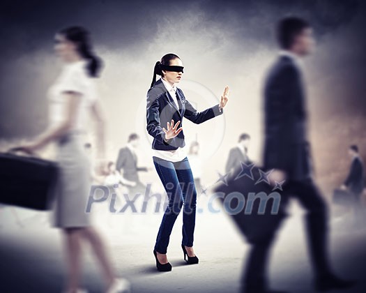 Image of businesswoman in blindfold walking among group of people