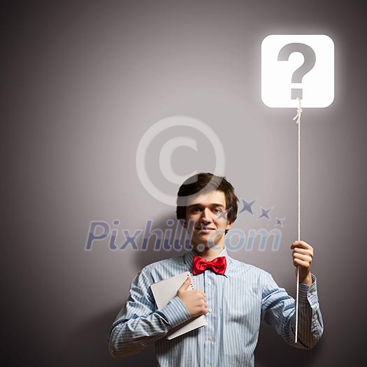 Image of young confused businessman holding notebook Image of young confused businessman holding notebook
