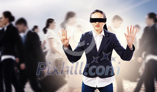 Image of businesswoman in blindfold walking among group of people