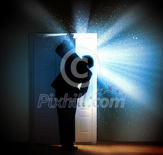 Image of young businessman standing with back opening door