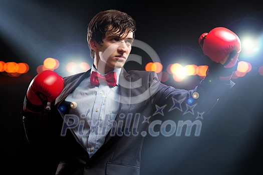 Portrait of a young businessman boxing. conceptual collage