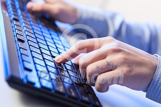 Click! Hands of a man on a keyboard with blue backlighting. Click! Hands of a man on a keyboard with blue backlighting.