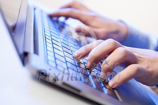Click! Hands of a man on a keyboard with blue backlighting. Click! Hands of a man on a keyboard with blue backlighting.