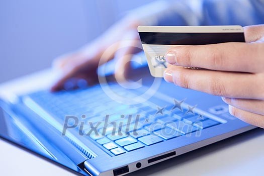 Click! Hands of a man on a keyboard with blue backlighting. Click! Hands of a man on a keyboard with blue backlighting.