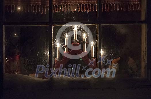 electric candlestick in frosty window