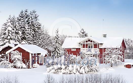 Red wooden houses in snow landscape
