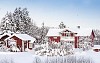 Red wooden houses in snow landscape