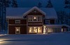 A red house at night with snow and christmas lights in the windows