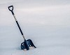 A blue snow shovel in the snow