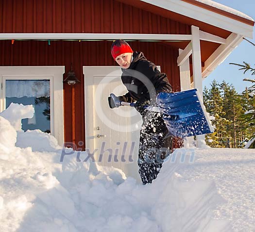 Woman shoveling snow in front of the house